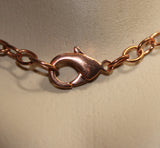 handcrafted copper teardrop pendant with turquoise center bead on copper chain