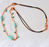 long turquoise necklace with copper chain and brown leather cord