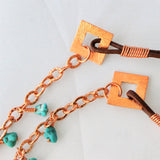 long turquoise necklace with copper chain and brown leather cord