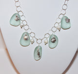 seafoam colored sea glass and charms with freshwater pearls on sterling chain necklace
