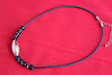 large bronze etched melon bead with black beads on black leather cord