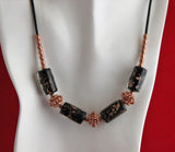 lampwork beads with copper swirls and copper beads on black leather cord