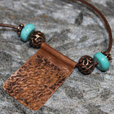 copper pendant with copper and turquoise beads on leather cord