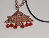 embossed copper pendant and south american topaz beads on copper chain and leather cord