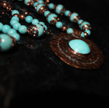 embossed copper pendant necklace with turquoise cab and turquoise coral fossil beads
