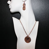 handcrafted embossed round wisteria patinaed copper pendant on chain with matching earrings