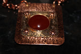 textured copper and brass rectangular pendant with carnelian cabochon on copper chain