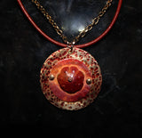 patinaed brass with red orange flower pendant on brick red leather cord and gold chain
