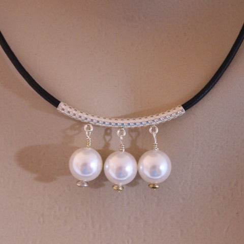 three white swarovski crystal pearls on sterling tube and black leather cord