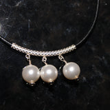 three white swarovski crystal pearls on sterling tube and black leather cord